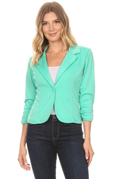 Solid, waist length blazer in a fitted style, with a button closure, and ruched sleeves