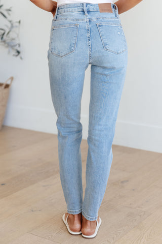 Mid rise control top distressed skinny jeans back view