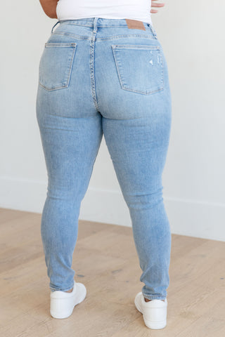 Mid rise control top distressed skinny jeans back view